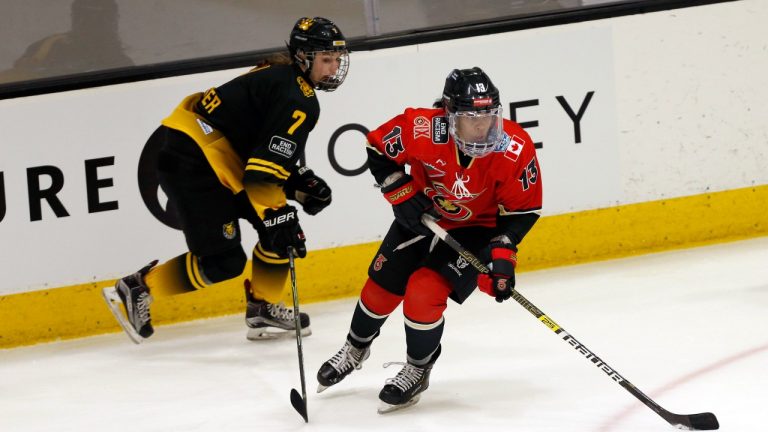 Toronto Six forward Mikyla Grant-Mentis (13) looks to pass the puck as Boston Pride forward Mary Parker (7) defends during the first period of a semifinal in the NWHL Isobel Cup hockey tournament Friday, March 26, 2021, in Boston. (Mary Schwalm/AP Photo)