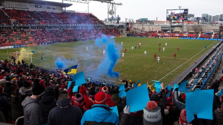 Toronto FC's fans set off blue and yellow flares and hold up coloured cards to show their support for Ukraine during first half MLS action against New York Red Bulls in Toronto, Saturday, March 5, 2022. (Chris Young/CP)