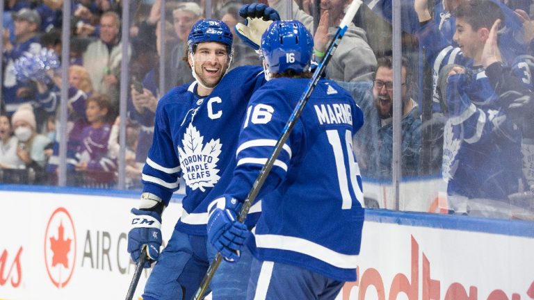 Toronto Maple Leafs' John Tavares (91) celebrates with teammate Mitchell Marner after scoring the team's third goal and his second of the game during second period NHL hockey action against the Florida Panthers, in Toronto, Sunday, March 27, 2022. (Chris Young/CP)