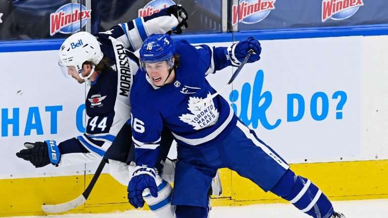 Winnipeg Jets defenceman Josh Morrissey (44) and Toronto Maple Leafs centre Mitchell Marner (16) collide during first period NHL action in Toronto on Saturday, March 13, 2021. (Frank Gunn/CP)