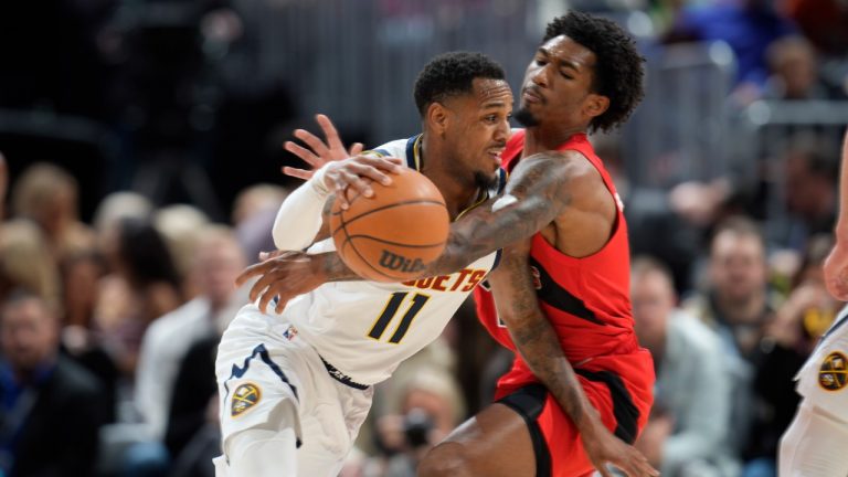 Denver Nuggets guard Monte Morris, left, drives to the basket as Toronto Raptors guard Armoni Brooks defends in the first half of an NBA basketball game Saturday, March 12, 2022, in Denver. (David Zalubowski/AP)