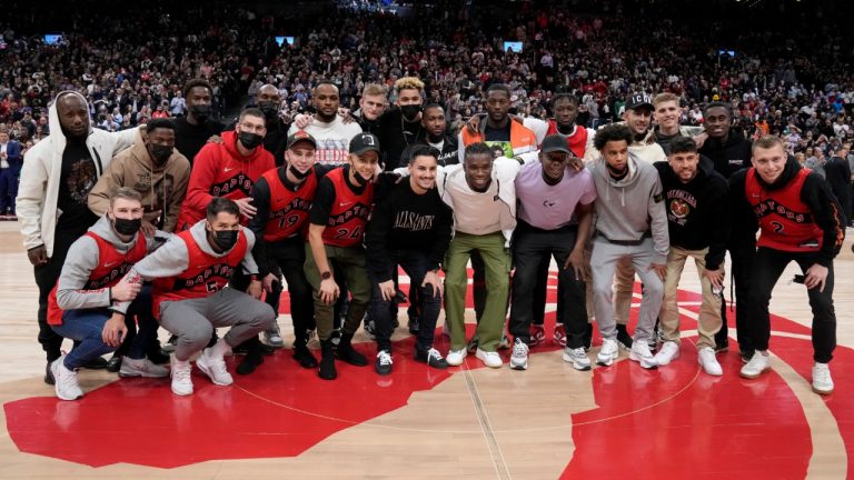 The Canadian men's national soccer team pose for a photo on the court during a break in play during first half NBA basketball action between the Toronto Raptors and the Boston Celtics, in Toronto, Monday, March 28, 2022. (Frank Gunn/CP)