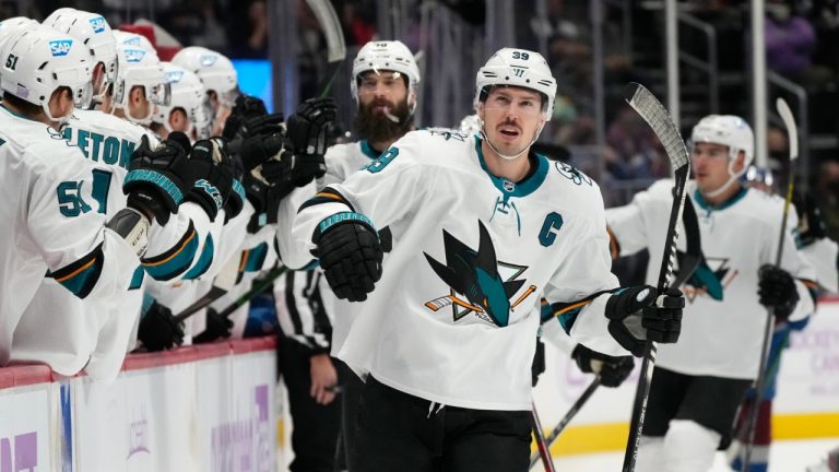 San Jose Sharks center Logan Couture, front is congratulated after scoring a goal against the Colorado Avalanche during the first period of an NHL hockey game Saturday, Nov. 13, 2021, in Denver. (David Zalubowski/AP)