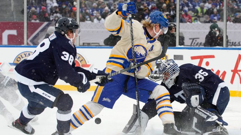 Toronto Maple Leafs defenceman Rasmus Sandin (38) ties up Buffalo Sabres defenceman Rasmus Dahlin (26) in front of Leafs goaltender Petr Mrazek (35)during first period NHL Heritage Classic hockey action. (Frank Gunn/CP)