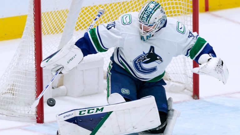 Vancouver Canucks goaltender Thatcher Demko turns away a shot during the first period of the team's NHL hockey game against the Dallas Stars in Dallas, Saturday, March 26, 2022. (LM Otero/AP)