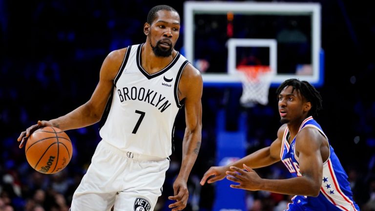 Brooklyn Nets' Kevin Durant, left, dribbles past Philadelphia 76ers' Tyrese Maxey during the second half of an NBA basketball game, Thursday, March 10, 2022, in Philadelphia. (Matt Slocum/AP)