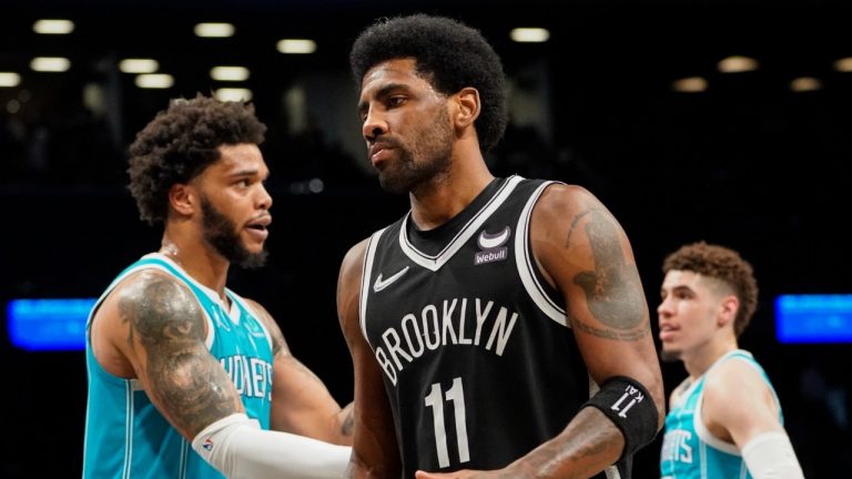 Brooklyn Nets guard Kyrie Irving (11) reacts to a referee call alongside Charlotte Hornets forward Miles Bridges, left, and guard LaMelo Ball, right, in the second half of an NBA basketball game, Sunday, March 27, 2022, in New York. (John Minchillo/AP)