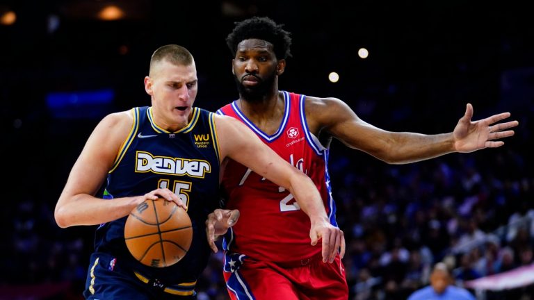 Denver Nuggets' Nikola Jokic, left, tries to get past Philadelphia 76ers' Joel Embiid during the first half of an NBA basketball game, Monday, March 14, 2022, in Philadelphia. (Matt Slocum/AP)