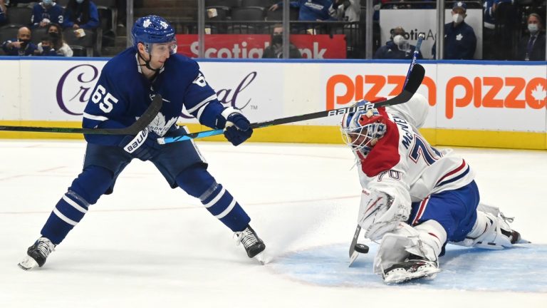 Montreal Canadiens goaltender Michael McNiven, right, makes a save on Toronto Maple Leafs’ Iiya Mikheyev during the third period of their NHL preseason hockey game in Toronto on Saturday, Sept. 25, 2021. (Jon Blacker/CP)