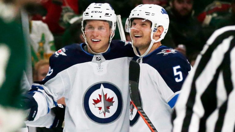 Winnipeg Jets defenseman Nelson Nogier (62) is congratulated by defenseman Dmitry Kulikov (5) after scoring a goal against the Minnesota Wild during the first period of a preseason NHL hockey game Wednesday, Sept. 26, 2018, in St. Paul, Minn. (Andy Clayton-King/AP)