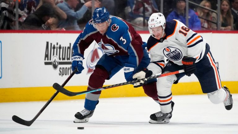 Colorado Avalanche defenceman Jack Johnson, left, pursues the puck with Edmonton Oilers left wing Zach Hyman in the second period of an NHL hockey game, Monday, March 21, 2022, in Denver. (David Zalubowski/AP Photo)