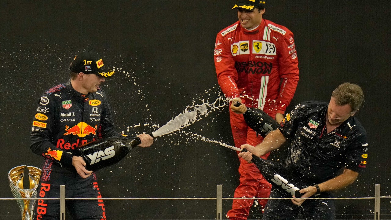 Red Bull team chief Christian Horner, right, celebrates with his driver Max Verstappen of the Netherlands after winning the Formula One Abu Dhabi Grand Prix in Abu Dhabi, United Arab Emirates, Sunday, Dec. 12, 2021. (Hassan Ammar/AP)