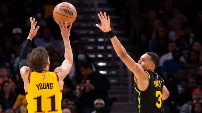 Atlanta Hawks guard Trae Young (11) shoots a 3-point basket over Golden State Warriors guard Jordan Poole (3) during the second half of an NBA basketball game Friday, March 25, 2022, in Atlanta. (Hakim Wright Sr./AP)