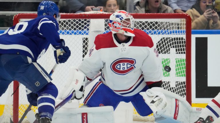 Toronto Maple Leafs centre Auston Matthews, not shown, scores on Montreal Canadiens goaltender Jake Allen (34) as Leafs left wing Michael Bunting (58) looks for a possible rebound during first period NHL hockey action in Toronto on Saturday, April 9, 2022. (Frank Gunn/CP)