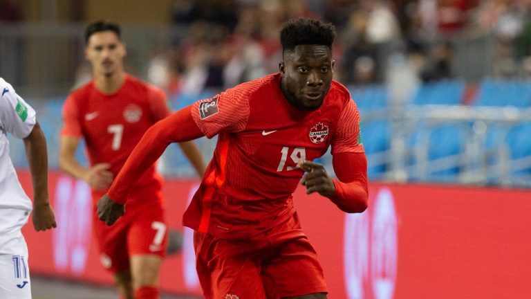 Canada's Alphonso Davies (right) takes the ball past Honduras' Andy Najar (left) during first half World Cup qualifying action in Toronto, on Thursday, September 2, 2021. Chris Young/CP)