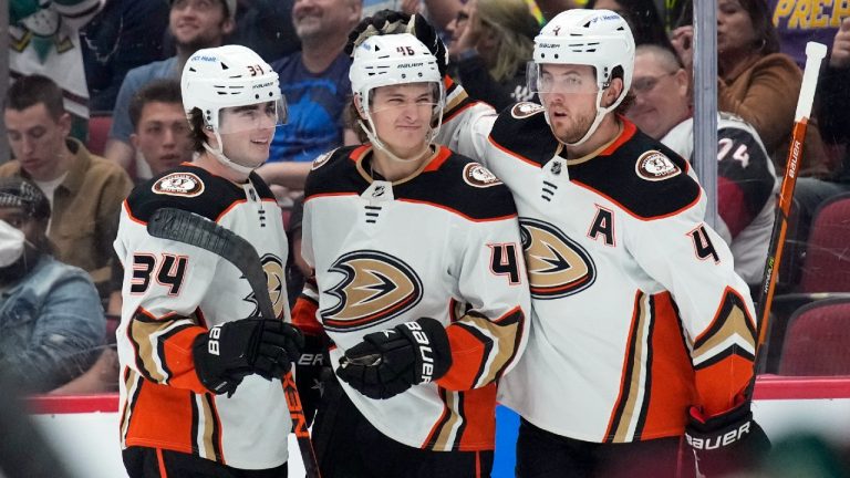 Anaheim Ducks center Trevor Zegras (46) celebrates with defensemen Jamie Drysdale (34) and Cam Fowler (4) after scoring a goal against the Arizona Coyotes during the first period of an NHL hockey game Friday, April 1, 2022, in Glendale, Ariz. (Rick Scuteri/AP)