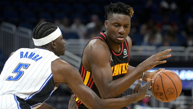 Orlando Magic center Mo Bamba (5) defends as Atlanta Hawks center Clint Capela drives to the basket during the first half of an NBA basketball game Wednesday, Feb. 16, 2022, in Orlando, Fla. (Phelan M. Ebenhack/AP)