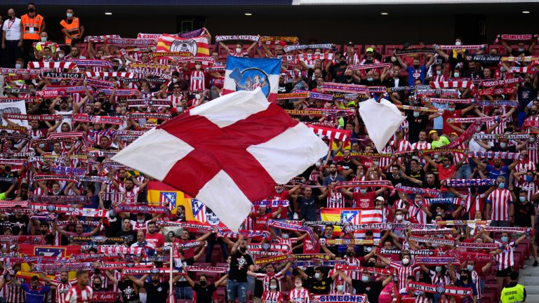 Atletico Madrid fans wave their scarves and flags during a Spanish La Liga soccer match between Atletico Madrid and Athletic Bilbao at Wanda Metropolitano stadium in Madrid, Spain, Saturday, Sept. 18, 2021. (Manu Fernandez/AP)