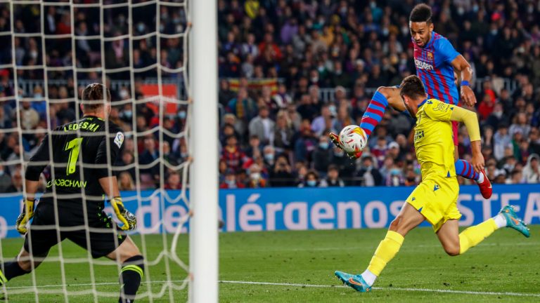 Barcelona's Pierre-Emerick Aubameyang, right, tries a shot during a Spanish La Liga soccer match between FC Barcelona and Cadiz at the Camp Nou stadium in Barcelona, Spain, Monday, April 18, 2022. (Joan Monfort/AP)