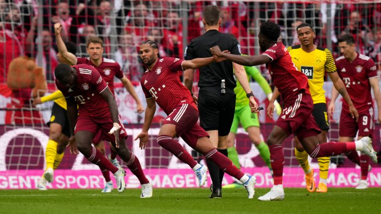 Bayern's Serge Gnabry, center, celebrates after scoring his side's opening goal during the German Bundesliga soccer match between Bayern Munich and Borussia Dortmund, at the Allianz Arena, in Munich, Germany, Saturday, April 23, 2022. (Matthias Schrader/AP)