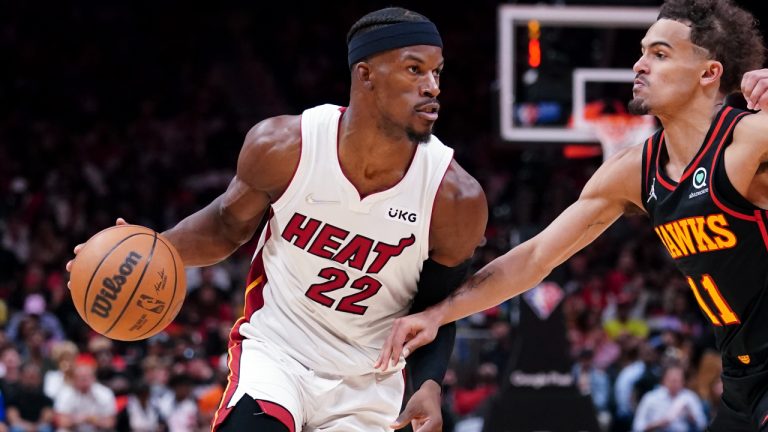 Miami Heat forward Jimmy Butler (22) drives against Atlanta Hawks guard Trae Young (11) in the first half of an NBA playoff basketball game Sunday, April 24, 2022, in Atlanta. (John Bazemore/AP)