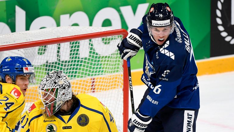 Finland's Axel Rindell, Sweden's Lias Andersson, left, and goalkeeper Niklas Rubin in action during the EHT ice hockey Karjala Cup match between Finland and Sweden in Helsinki, Finland, Sunday Nov. 8, 2020. (AP)