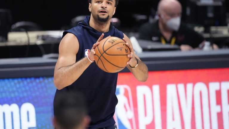 Injured Denver Nuggets guard Jamal Murray, from Kitchener, Ont., drew the ire of fans because he was able to participate in some aspects of the pre-game warmup, but could not play. (David Zalubowski/AP)