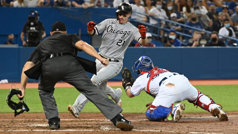 Chicago White Sox’s Zack Collins (21) is tagged out at home by Toronto Blue Jays’ catcher Alejandro Kirk, right, in the eighth inning of an American League baseball game in Toronto on Tuesday, Aug. 24, 2021. THE CANADIAN PRESS/Jon Blacker