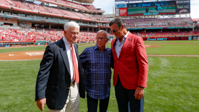 Cincinnati Reds announcer Marty Brennaman, center, stands with Reds owner Bob Castellini, left, and Phil Castellini, right, before a baseball game against the Milwaukee Brewers, Thursday, Sept. 26, 2019, in Cincinnati. The 77-year-old broadcaster is retiring after 46 years. (AP/file)