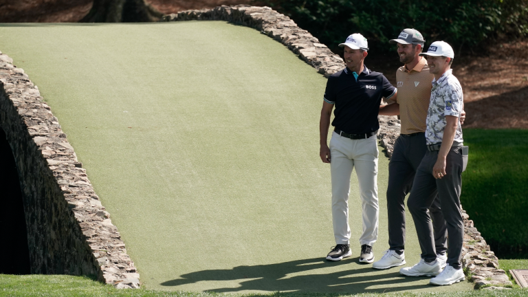 Mike Weir, left, Corey Conners, centre, and Mackenzie Hughes pose at the Ben Hogan Bridge during a practice round for the Masters on Monday, April 4, 2022, in Augusta, Ga. (AP/file)