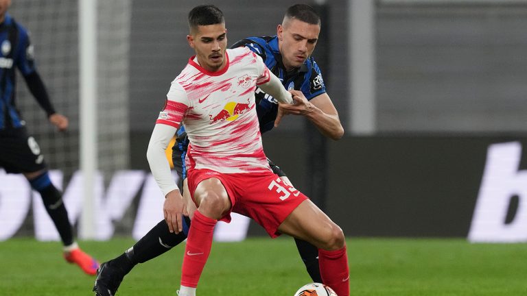 Leipzig's Andre Silva, left, and Atalanta's Merih Demiral fight for the ball during an Europa League quarterfinal soccer match between RB Leipzig and Atalanta, in Leipzig, Germany, Thursday, April 7, 2022. (Michael Sohn/AP)