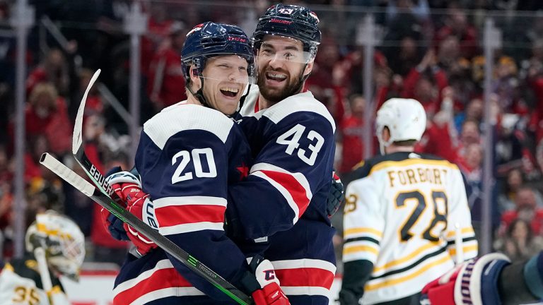 Washington Capitals center Lars Eller (20) celebrates his third period goal with right wing Tom Wilson (43) of an NHL hockey game against the Boston Bruins, Sunday, April 10, 2022, in Washington. The Capitals won 4-2. (Julio Cortez/AP)