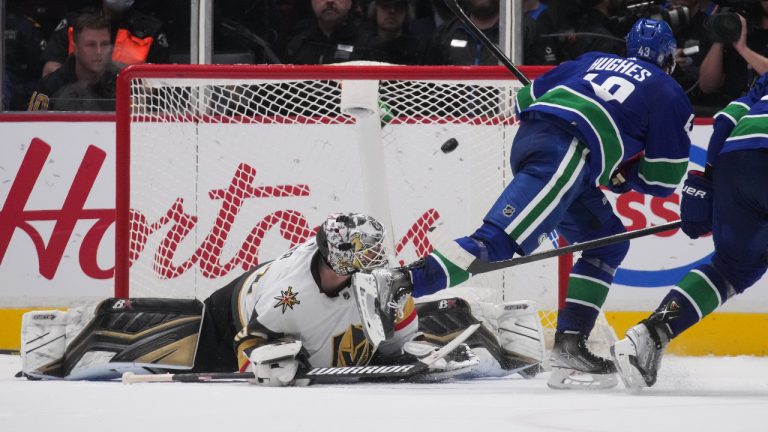 Vancouver Canucks' Quinn Hughes, right, scores the winning goal against Vegas Golden Knights goalie Robin Lehner, of Sweden, during overtime NHL hockey action in Vancouver, on Tuesday, April 12, 2022. THE CANADIAN PRESS/Darryl Dyck