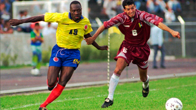 Colombian player Freddy Rincon, left, fights for the ball with Elvis Martinez of Venezuela during a qualifying France '98 game in San Cristobal, Venezuela, on Dec. 15, 1996. (AP/file)