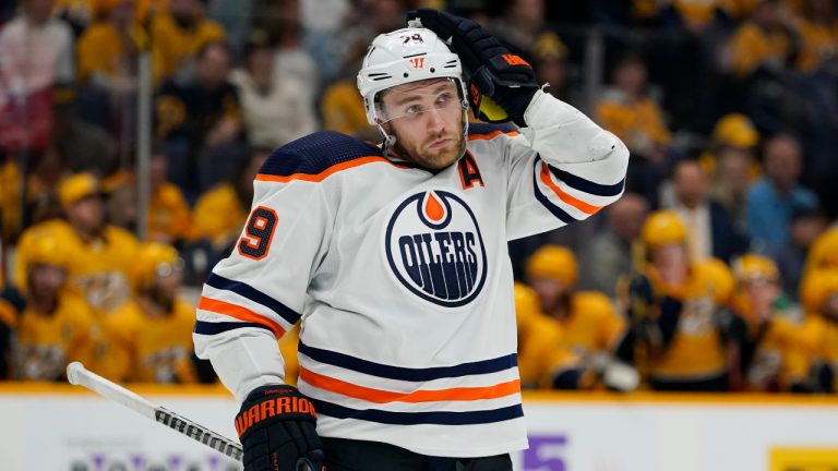 Edmonton Oilers' Leon Draisaitl adjusts his helmet in the third period of an NHL hockey game against the Nashville Predators Thursday, April 14, 2022, in Nashville, Tenn. Draisaitl scored three goals in the Oilers' 4-0 win. (AP Photo/Mark Humphrey)