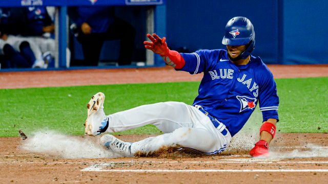 TORONTO, ON - APRIL 11: Toronto Blue Jays first baseman Vladimir Guerrero  Jr. (27) poses for the cameras after the opening ceremony pitch from Former Blue  Jays first baseman and recent Hall