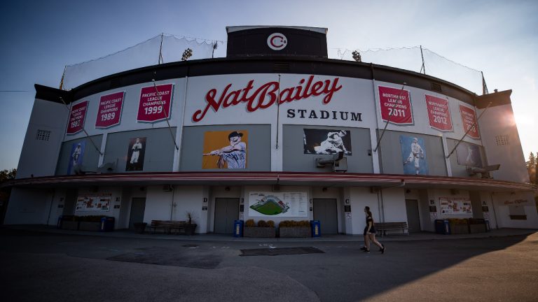 People walk past Nat Bailey Stadium during a fan batting practice session hosted by the Vancouver Canadians minor league baseball team, in Vancouver, on Thursday, September 3, 2020. THE CANADIAN PRESS/Darryl Dyck