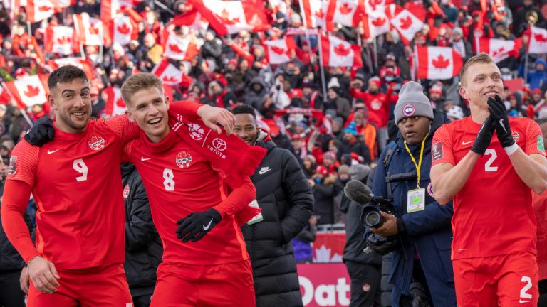 Members of Canada's national soccer team celebrate after clinching a berth in CONCACAF World Cup Qualifier soccer action against Jamaica in Toronto on Sunday March 27, 2022 (Frank Gunn/CP)