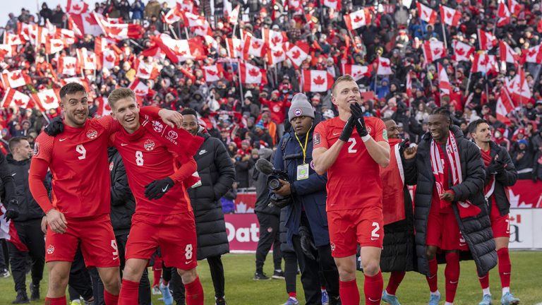 Members of Canada's national soccer team celebrate after clinching a berth in CONCACAF World Cup Qualifier soccer action against Jamaica in Toronto. (Frank Gunn/CP)