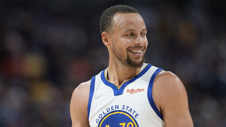 Golden State Warriors guard Stephen Curry smiles as he looks to the bench in the waning seconds of Game 3 of the team's NBA basketball first-round Western Conference playoff series against the Denver Nuggets. (David Zalubowski/AP)