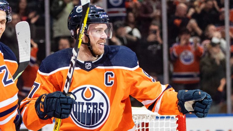 Edmonton Oilers' Connor McDavid (97) celebrates his 100th point of the season during second period NHL action against the Los Angeles Kings, in Edmonton on Wednesday, March 30, 2022. (Jason Franson/CP)