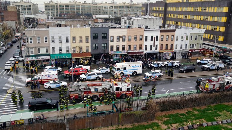 Emergency personnel gather at the entrance to a subway stop in the Brooklyn borough of New York, Tuesday, April 12, 2022. (John Minchillo/AP)