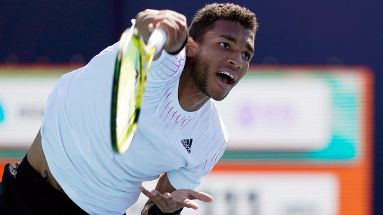 Felix Auger-Aliassime, of Canada, serves to Miomir Kecmanovic, of Serbia, during the Miami Open tennis tournament, Saturday, March 26, 2022, in Miami Gardens, Fla. (Wilfredo Lee/AP)