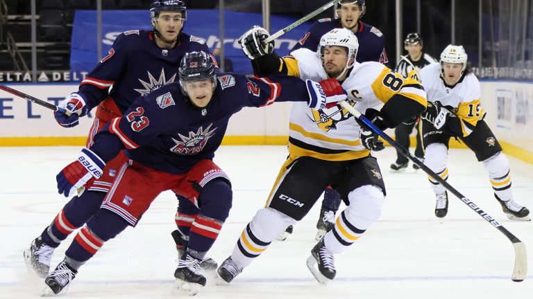 New York Rangers' Adam Fox (23) slows Pittsburgh Penguins' Sidney Crosby (87). (Bruce Bennett/Pool Photo via AP)