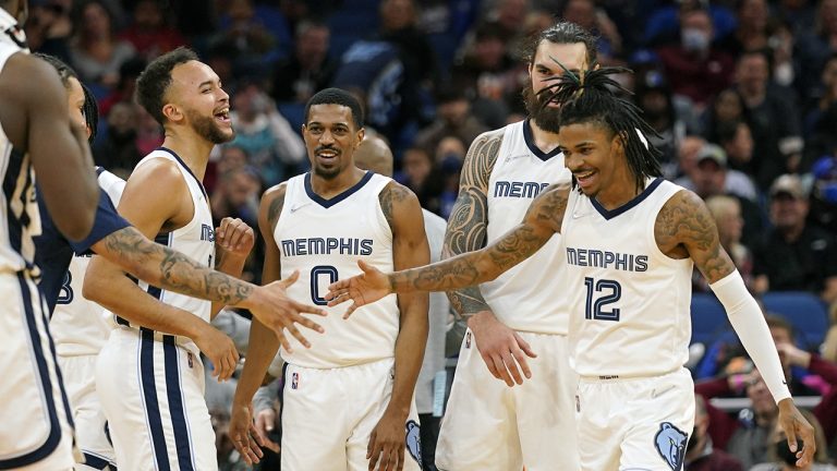 Memphis Grizzlies guard De'Anthony Melton (0) celebrates a big play against the Orlando Magic with teammates forward Kyle Anderson, left, center Steven Adams, second from right, and guard Ja Morant (12) during the second half of an NBA basketball game. (John Raoux/AP)