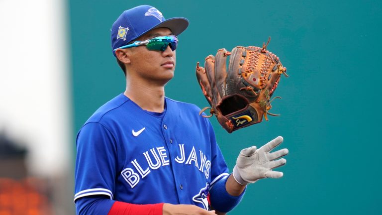 Toronto Blue Jays third baseman Gosuke Katoh of Japan tosses his glove during the first inning of a spring training baseball game against the Pittsburgh Pirates, Friday, April 1, 2022, in Bradenton, Fla. (Lynne Sladky/AP)