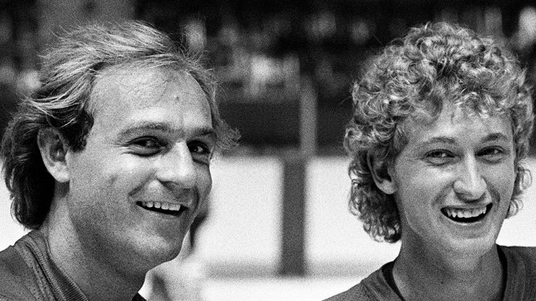 Wayne Gretzky of the Edmonton Oilers and Montreal Canadiens Guy Lafleur are seen here during a break in their light skate at the first day of training camp for Team Canada in Montreal, Aug. 10, 1981. (Ian MacAlpine/CP Photo)