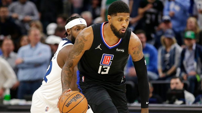 Los Angeles Clippers guard Paul George (13) drives past Minnesota Timberwolves guard Patrick Beverley (22) during the first quarter of an NBA basketball game Tuesday, April 12, 2022, in Minneapolis. (Andy Clayton-King/AP)