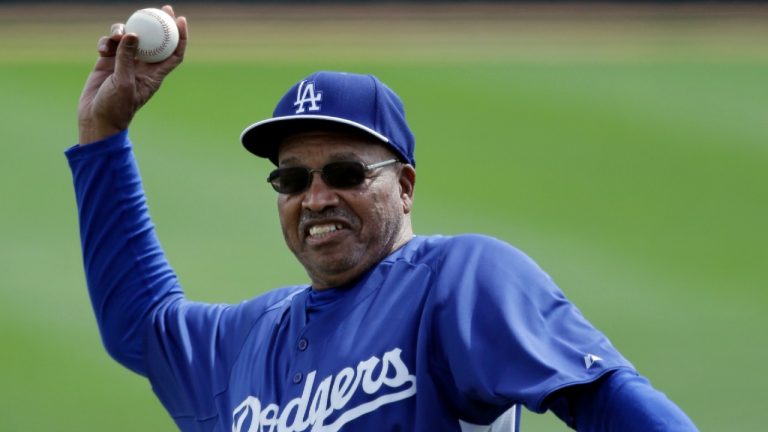 FILE - Former Los Angeles Dodgers great Tommy Davis throws out a ceremonial pitch before an exhibition spring training baseball game against the Seattle Mariners, Saturday, March 9, 2013, in Glendale, Ariz. Davis, a two-time National League batting champion who won three World Series titles with the Los Angeles Dodgers, died Sunday night, April 3, 2022, in Phoenix, the Dodgers announced Monday. He was 83. (Mark Duncan/AP)