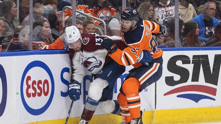 Colorado Avalanche right wing Valeri Nichushkin (13) and Edmonton Oilers' Connor McDavid (97) battle for the puck during first period NHL action. (Jason Franson/CP)